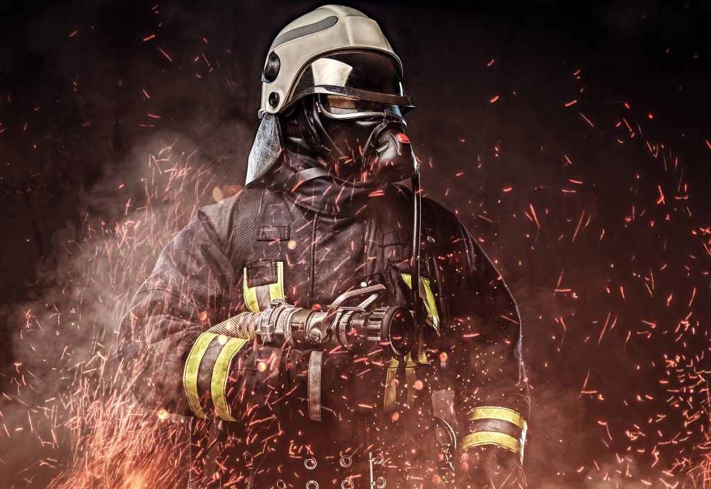 professional firefighter dressed uniform oxygen mask standing fire sparks smoke dark background